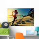young fitness woman running on seaside stone stairs Wall Mural