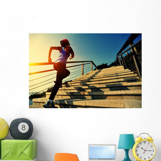 young fitness woman running on seaside stone stairs Wall Mural