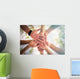 Hands of young people close up on sunny nature background Wall Mural