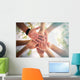 Hands of young people close up on sunny nature background Wall Mural