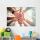 Hands of young people close up on sunny nature background Wall Mural