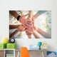 Hands of young people close up on sunny nature background Wall Mural