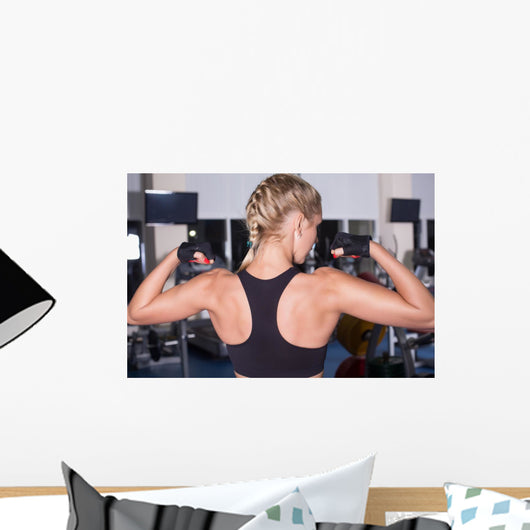 Strong woman shows her muscles Wall Mural