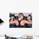 Strong woman shows her muscles Wall Mural