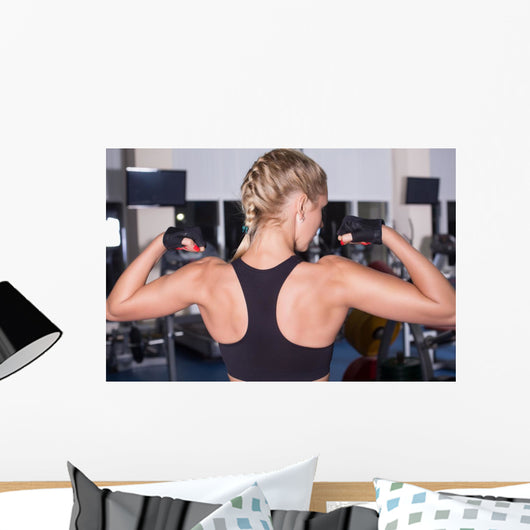 Strong woman shows her muscles Wall Mural