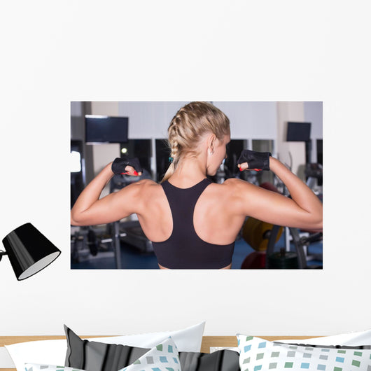 Strong woman shows her muscles Wall Mural