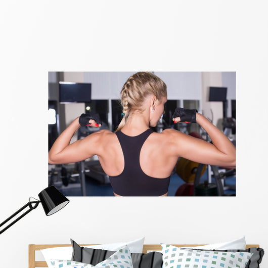 Strong woman shows her muscles Wall Mural