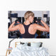 Strong woman shows her muscles Wall Mural