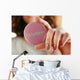 Round volunteer button in hand close-up Wall Mural