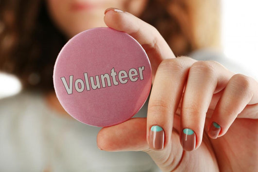 Round Volunteer Button In Hand Close-Up Wall Decal