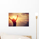 cheering woman open arms at sunrise seaside Wall Mural
