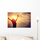 cheering woman open arms at sunrise seaside Wall Mural