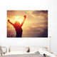 cheering woman open arms at sunrise seaside Wall Mural