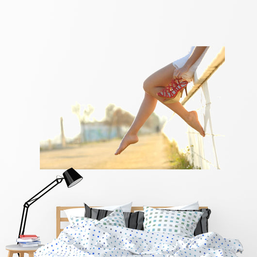 Woman legs silhouette with heels hanging of her hands Wall Mural