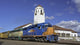 Train Engine Pulls Its Cars By The Depot With Blue Sky Wall Decal