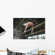 Athlete topless doing exercises on the uneven bars Wall Mural
