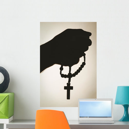 Hand holding rosary beads Wall Mural