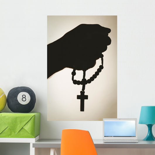 Hand holding rosary beads Wall Mural