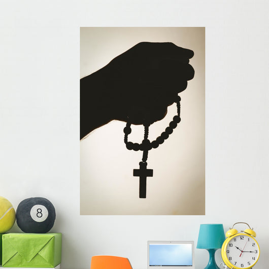 Hand holding rosary beads Wall Mural