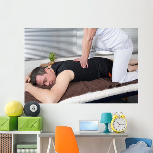 One man and woman performing back shiatsu massage Wall Mural