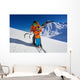 Father give mountain ski lesson to little boy Wall Mural