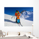 Father give mountain ski lesson to little boy Wall Mural