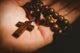Hand Holding Wooden Rosary Beads Wall Decal