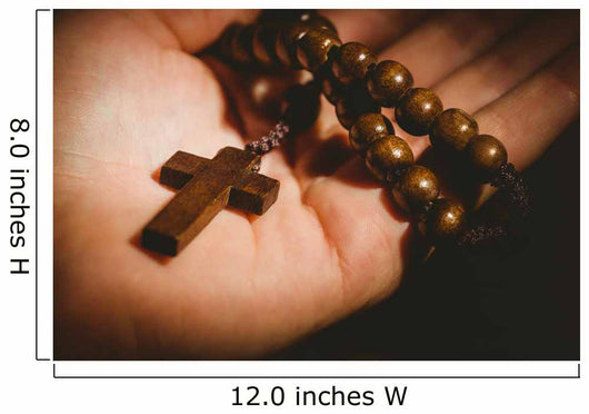 Hand holding wooden rosary beads Wall Mural