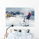 Young female skier admiring the stunning view Wall Mural