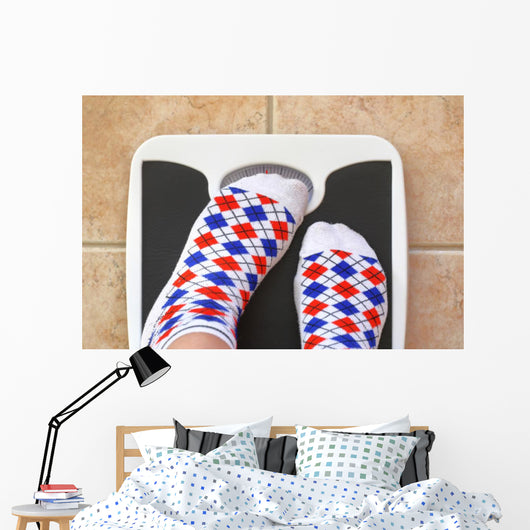 Woman's feet on bathroom scale. Diet concept Wall Decal