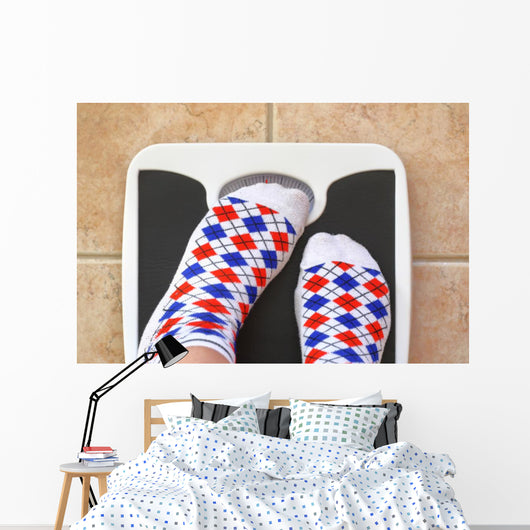 Woman's feet on bathroom scale. Diet concept Wall Decal