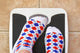 Woman's Feet On Bathroom Scale. Diet Concept Wall Decal