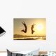 Fitness couple jumping happy at sunset Wall Mural