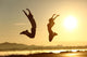Fitness Couple Jumping Happy At Sunset Wall Decal