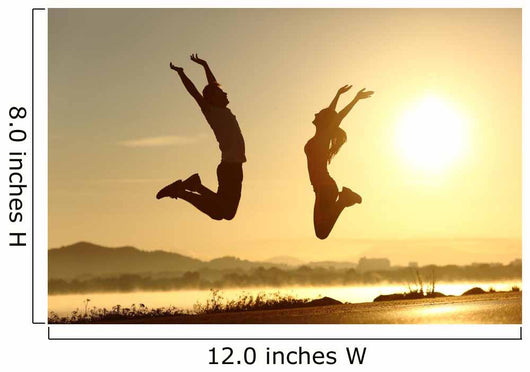 Fitness couple jumping happy at sunset Wall Mural
