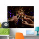 Clinking glasses of champagne in hands on lights background Wall Mural