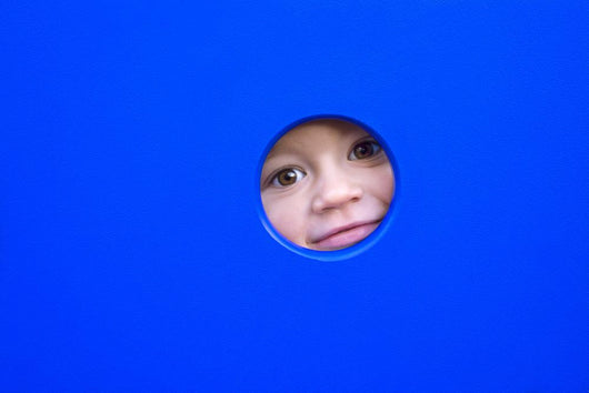 Little Kid Playing Peek-A-Boo On A Playground Wall Decal