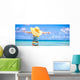 Little girl in big yellow hat on white sandy beach Wall Mural