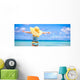 Little girl in big yellow hat on white sandy beach Wall Mural