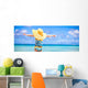 Little girl in big yellow hat on white sandy beach Wall Mural