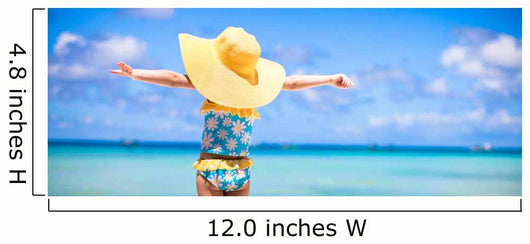 Little girl in big yellow hat on white sandy beach Wall Mural