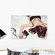 Pretty girl lying on the bed in bra with a camera Wall Mural
