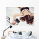 Pretty girl lying on the bed in bra with a camera Wall Mural