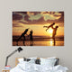 Father and children playing on the beach Wall Mural