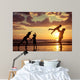 Father and children playing on the beach Wall Mural