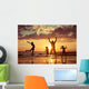 Father and children playing on the beach Wall Mural