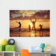 Father and children playing on the beach Wall Mural