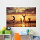Father and children playing on the beach Wall Mural