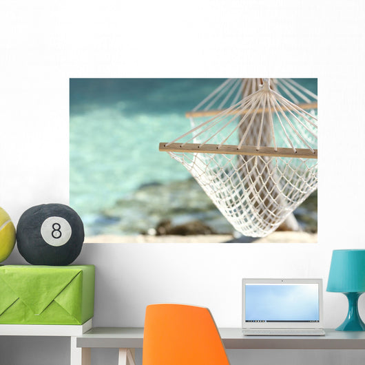 Travel concept with a hammock in a tropical beach Wall Mural