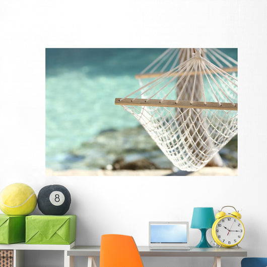 Travel concept with a hammock in a tropical beach Wall Mural